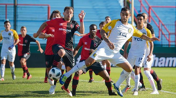 Jugadores de Rosario Central y Newell's disputando una pelota en un partido reciente